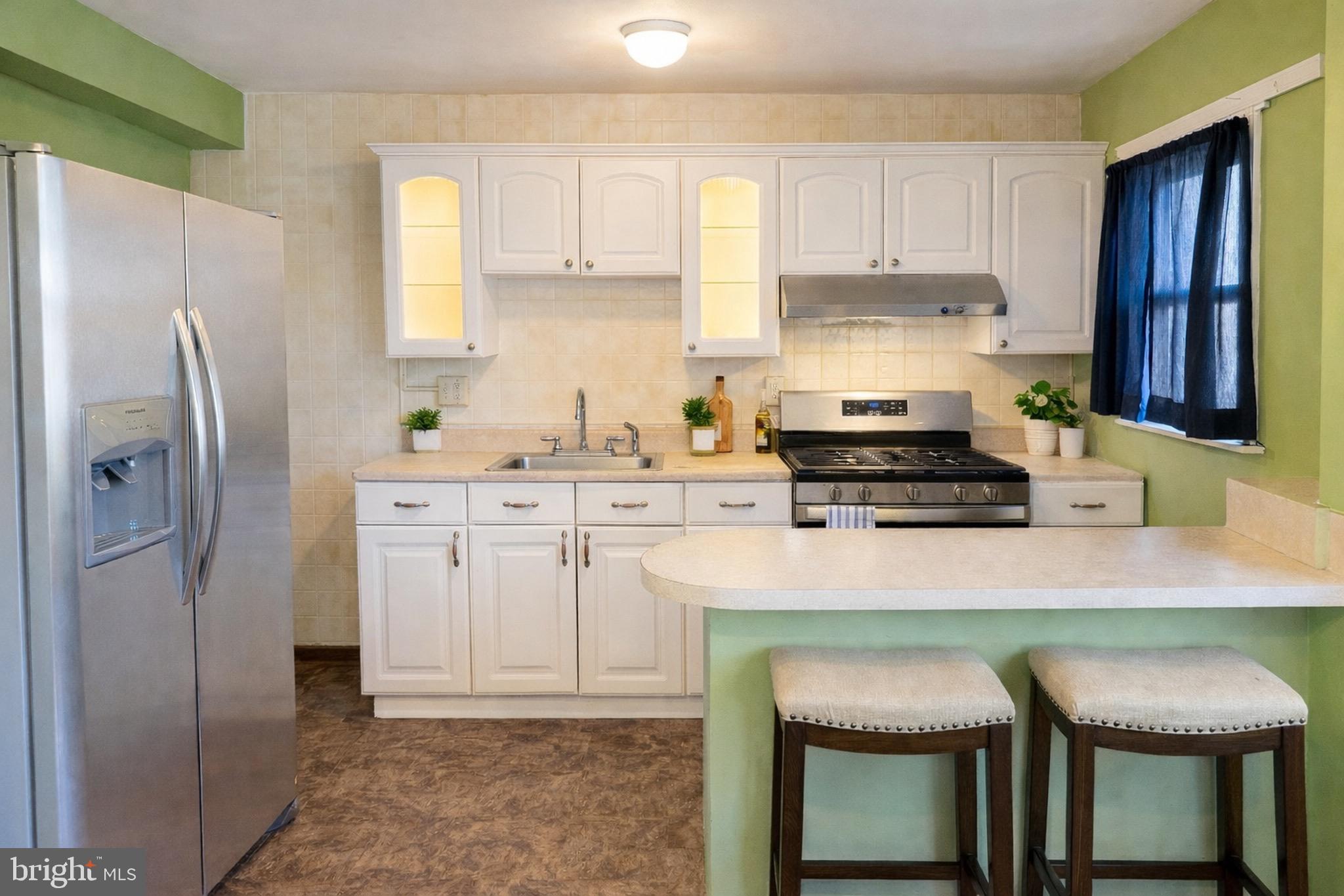 8418 Kavanagh Road Baltimore, MD 21222 - Photo 5 of 24 a kitchen with a refrigerator a stove a sink and a cabinets