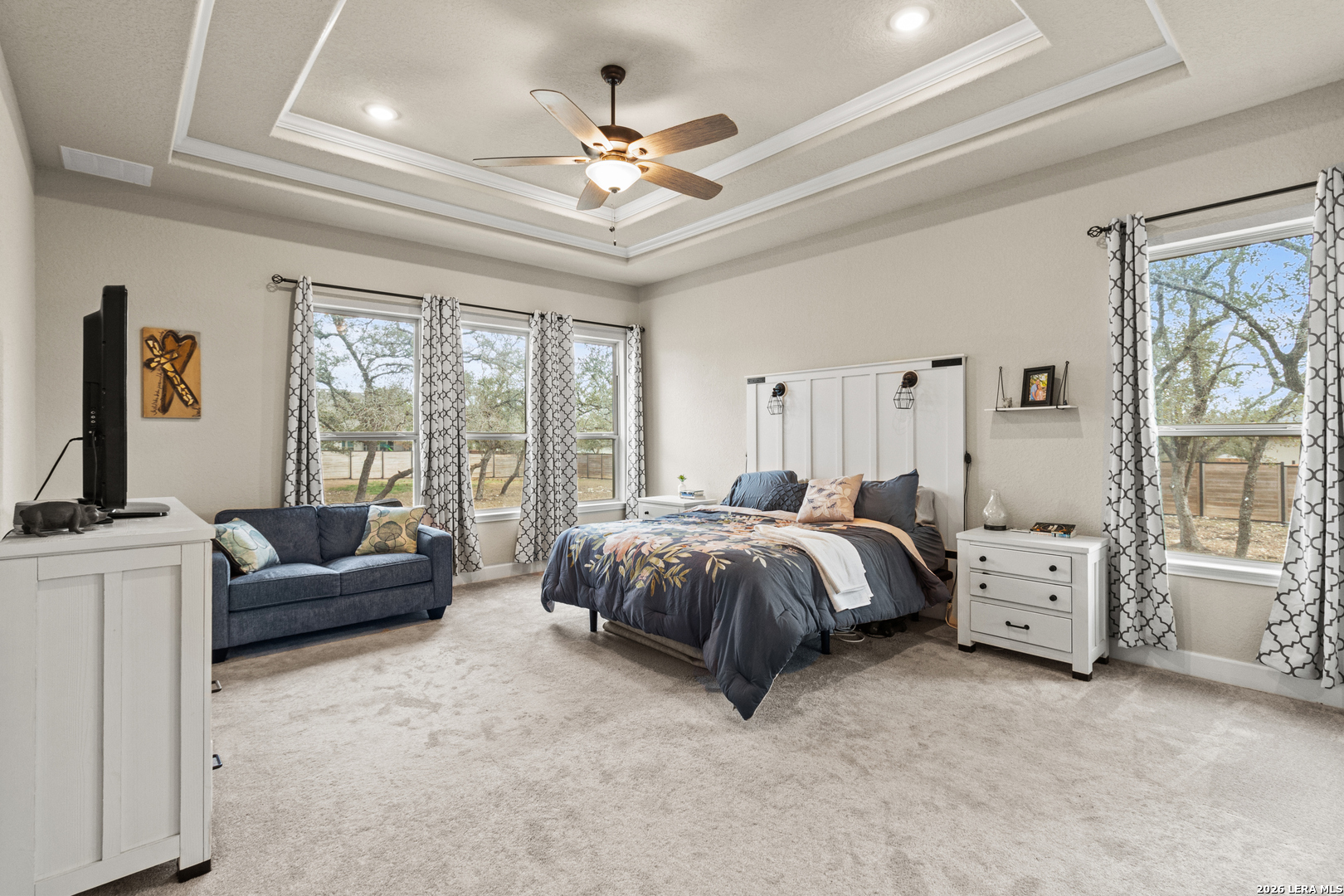 527 James Way Castroville, TX 78009 - Photo 12 of 32 a spacious bedroom with a bed and a couch