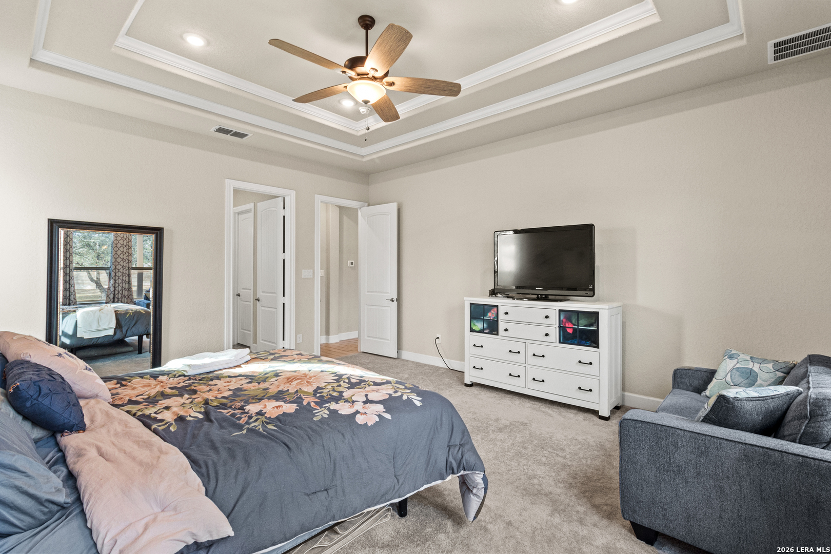 527 James Way Castroville, TX 78009 - Photo 14 of 32 a bedroom with a bed and a flat screen tv