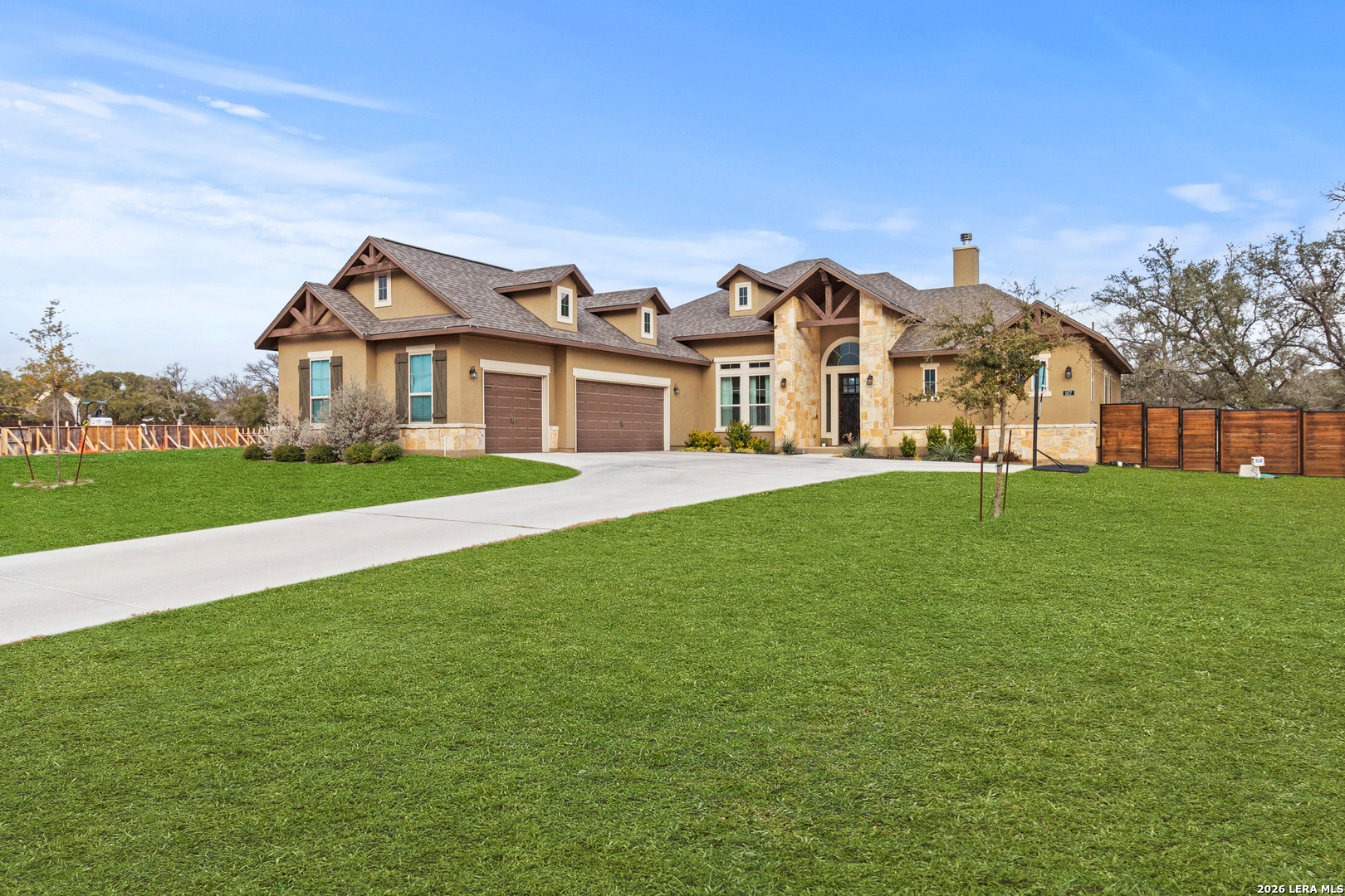 527 James Way Castroville, TX 78009 - Photo 2 of 32 a front view of a building with a garden