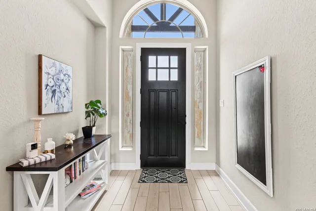 a view of a hallway view with wooden floor and staircase