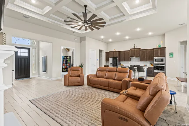 a living room with furniture and a chandelier
