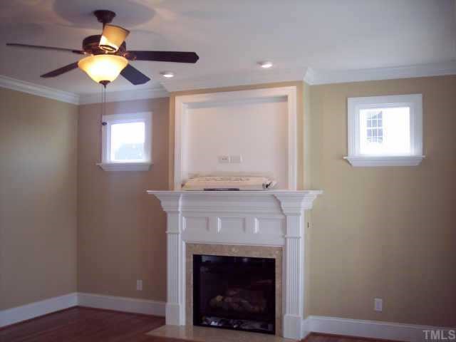1328 Ileagnes Road Raleigh, NC 27603 - Photo 11 of 12 a view of an empty room with a fireplace and wooden floor