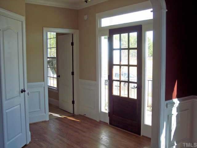 1328 Ileagnes Road Raleigh, NC 27603 - Photo 2 of 12 an empty room with wooden floor and windows
