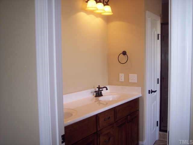 1328 Ileagnes Road Raleigh, NC 27603 - Photo 4 of 12 a bathroom with a sink and a mirror