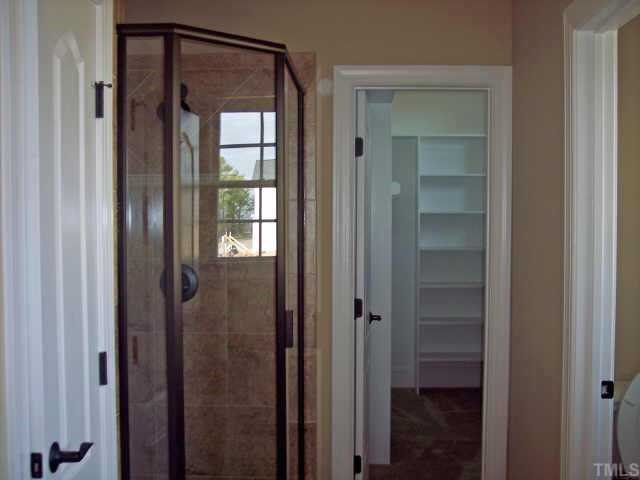 1328 Ileagnes Road Raleigh, NC 27603 - Photo 5 of 12 a bathroom with a glass door