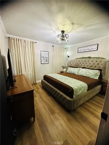 a bedroom with a bed lamps and a desk