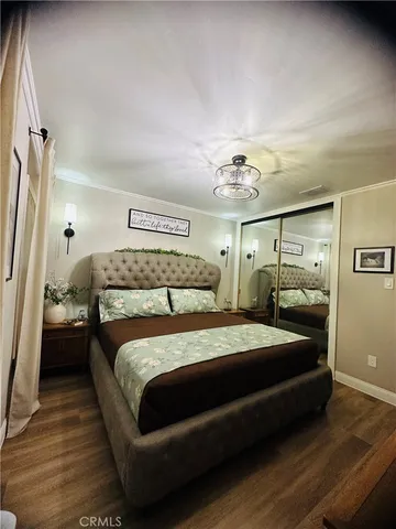 a bedroom with a large bed and a chandelier