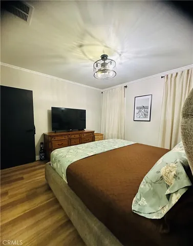 a bedroom with a bed and a television