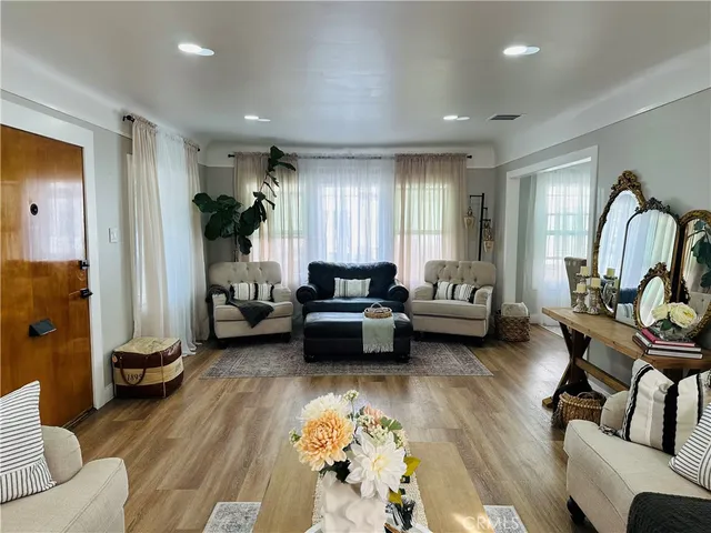 a living room with furniture or couch and a potted plant