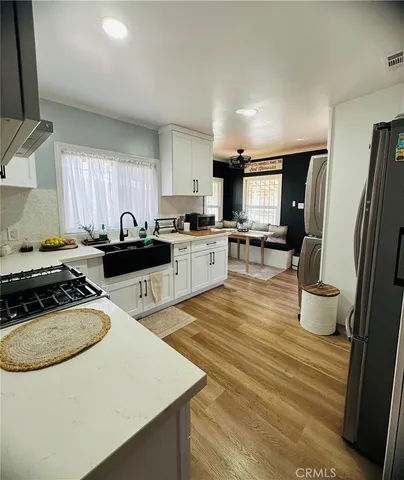 a kitchen with a sink a stove a refrigerator and cabinets