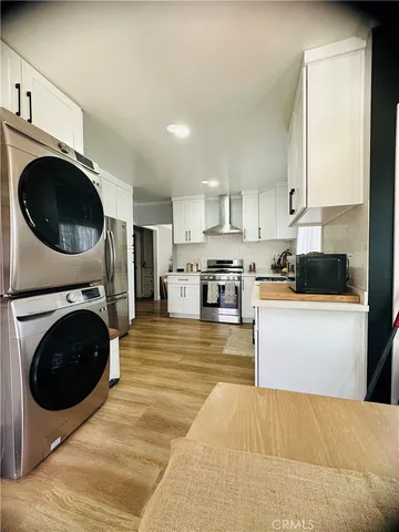 a kitchen with a washer and dryer in it