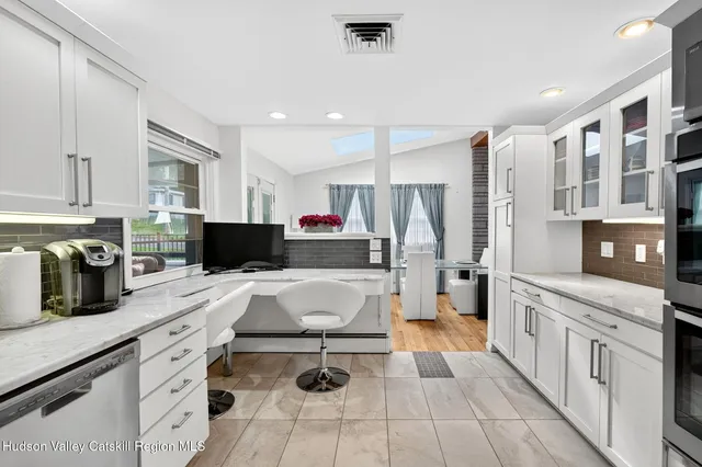 a bathroom with a granite countertop sink mirror and toilet
