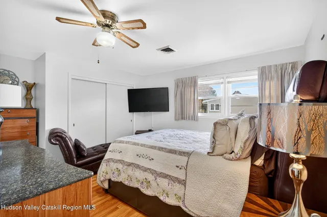 a bathroom with a tub a mirror and a shower