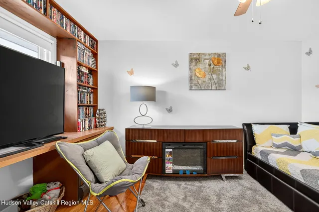 a living room with furniture a flat screen tv and a fireplace