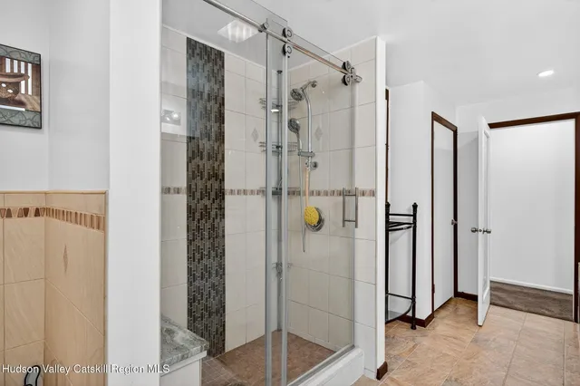 a view of a tables and chairs under an umbrella in backyard