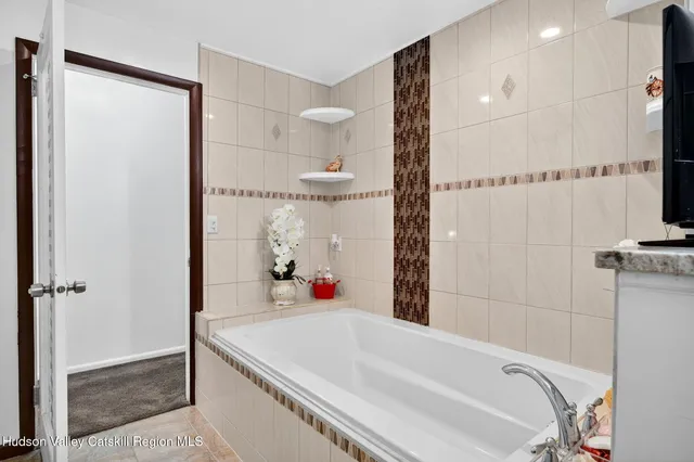 a view of two chairs and table in the patio