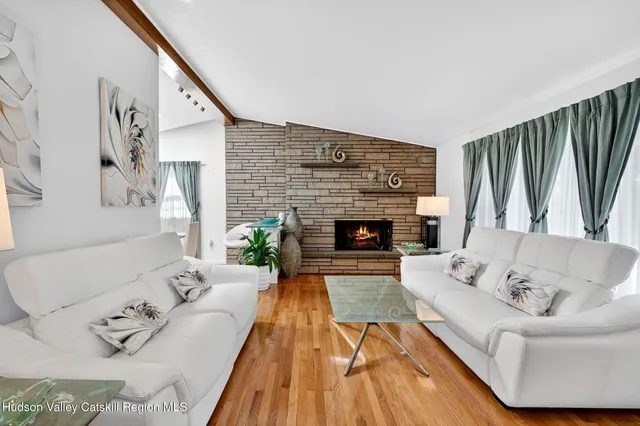 a dining room with furniture and a window