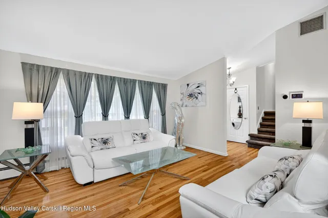 a kitchen with white cabinets and appliances