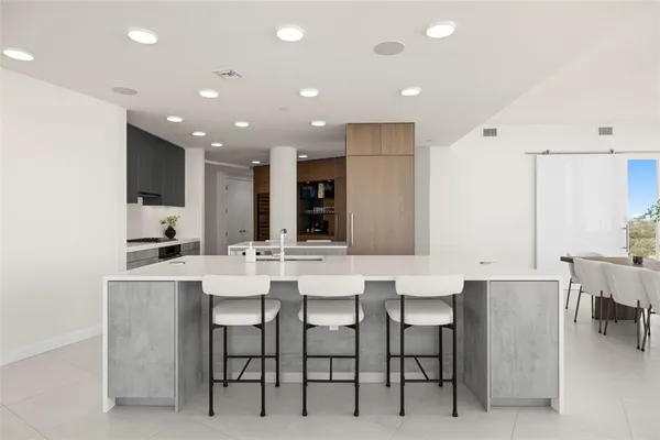 a large white kitchen with a large sink