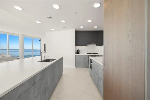 a kitchen with stainless steel appliances a stove a sink and cabinets