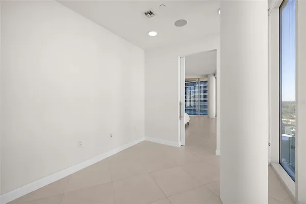 a spacious bedroom with a bed and a cabinets