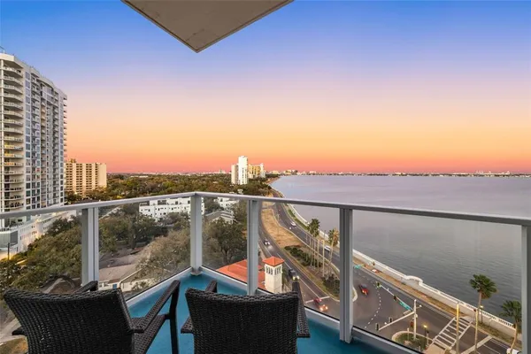 a kitchen with a large window and a view of living room