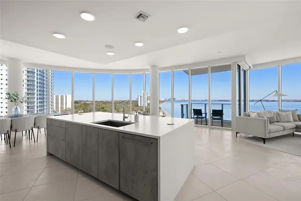 a kitchen with a table chairs refrigerator and microwave