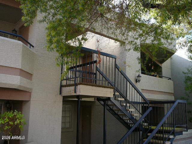 a view of a balcony with wooden floor and fence