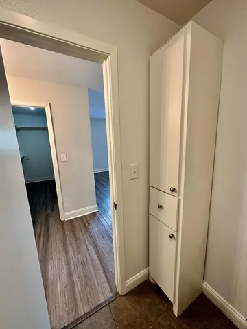 a view of a hallway with wooden floor