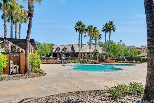 a front view of multi story residential apartment building with yard and green space