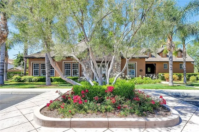 a view of a house with a garden and pathway