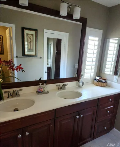 a bathroom with a double vanity sink and a mirror