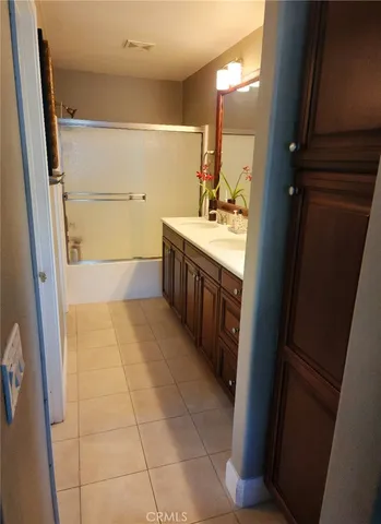 a bathroom with a granite countertop sink a mirror and a bathtub