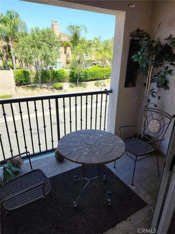 a balcony with table and chairs
