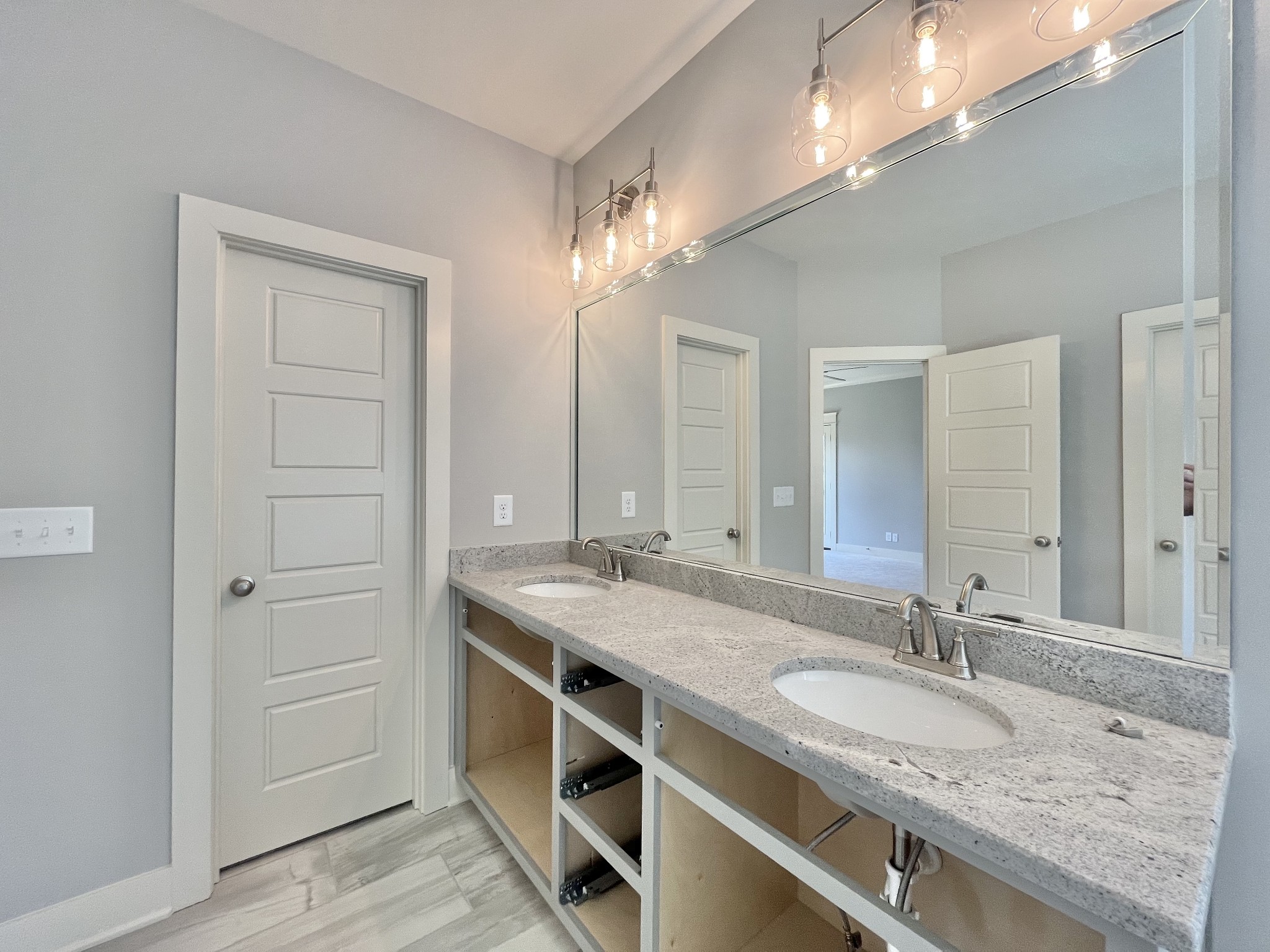 813 Ridgestone Place, Unit 99 Lebanon, TN 37087 - Photo 17 of 24 a bathroom with a granite countertop sink and a mirror