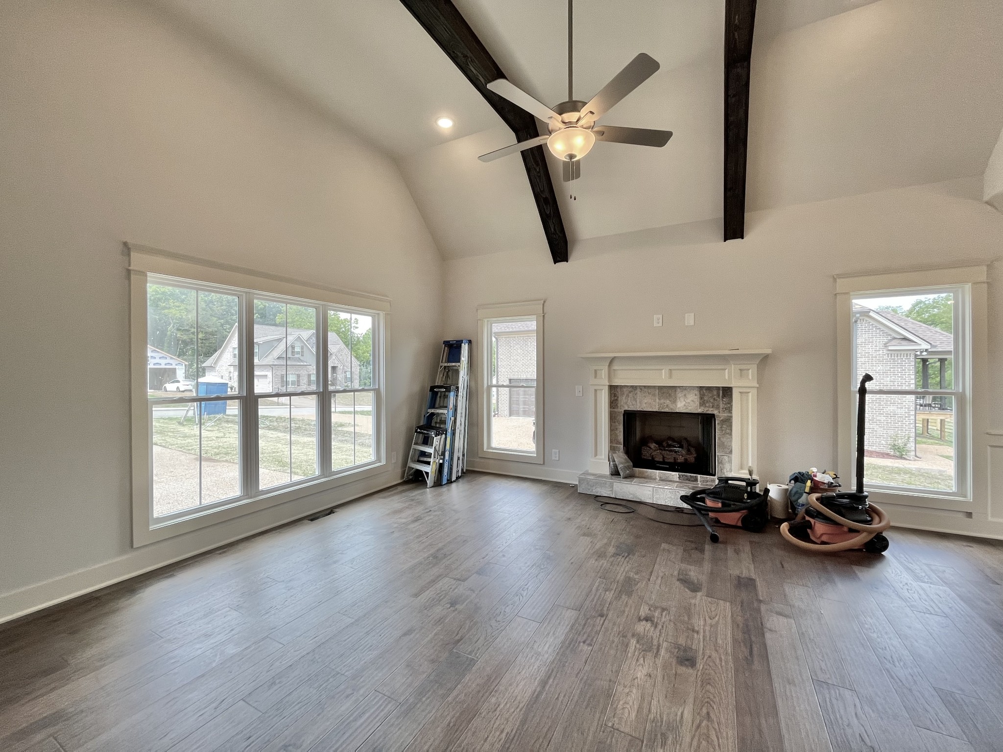 813 Ridgestone Place, Unit 99 Lebanon, TN 37087 - Photo 4 of 24 a view of a livingroom with a fireplace a ceiling fan and wooden floor