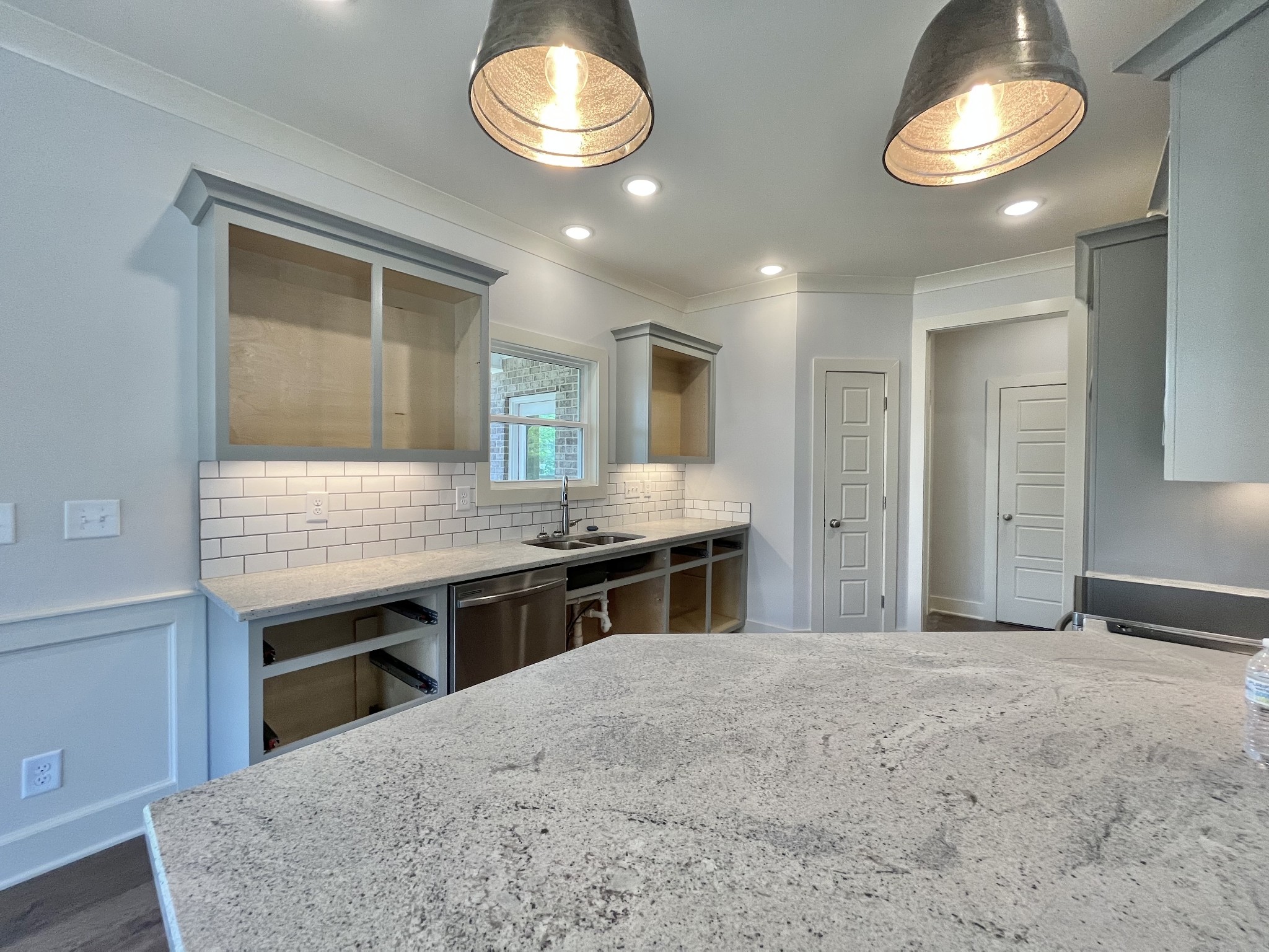 813 Ridgestone Place, Unit 99 Lebanon, TN 37087 - Photo 7 of 24 a kitchen with stainless steel appliances granite countertop a stove and a sink