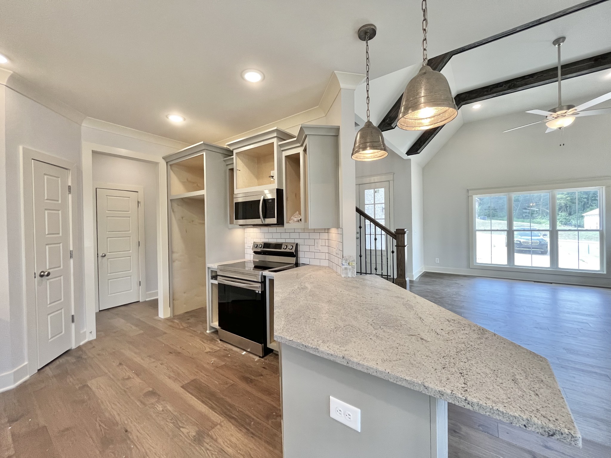 813 Ridgestone Place, Unit 99 Lebanon, TN 37087 - Photo 8 of 24 a kitchen with stainless steel appliances granite countertop a sink a stove and a wooden floors