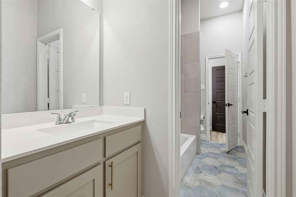 5640 Pradera Road Fort Worth, TX 76126 - Photo 23 of 35 Vanity with an integrated sink and chrome faucet
