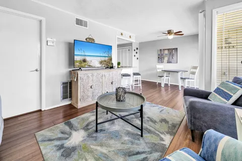 a dining room with furniture and wooden floor