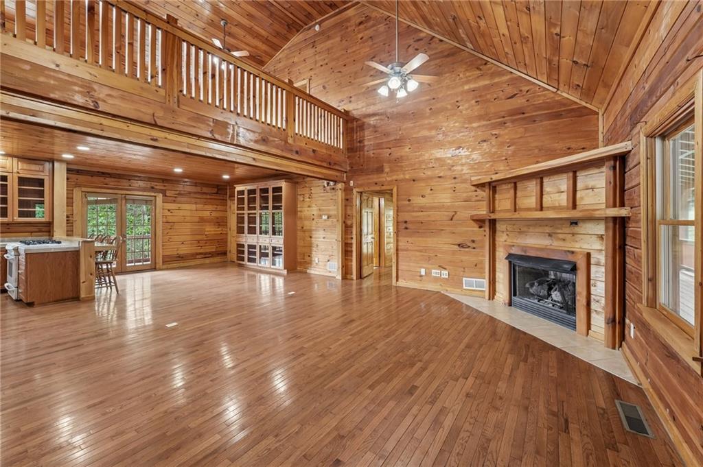 1384 Crystal Lane Northeast Ranger, GA 30734 - Photo 6 of 89 a view of an empty room with wooden floor fireplace and a window