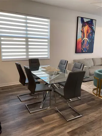 a view of a dining room with furniture and wooden floor