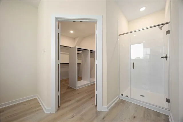 a bathroom with a shower and a glass door