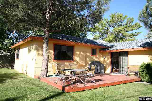 4490 Persimmon Road Reno, NV 89502 - Photo 3 of 6 a view of a backyard with table and chairs under an umbrella