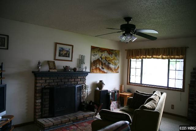 4490 Persimmon Road Reno, NV 89502 - Photo 4 of 6 a living room with furniture and a fireplace
