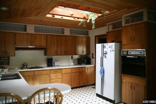 4490 Persimmon Road Reno, NV 89502 - Photo 6 of 6 a kitchen with stainless steel appliances a refrigerator a sink a stove and cabinets