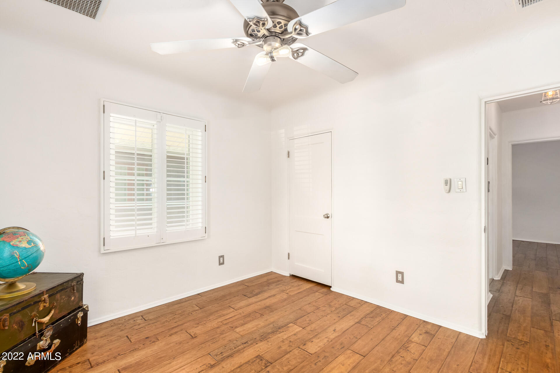 1330 East Granada Road Phoenix, AZ 85006 - Photo 19 of 24 a view of an empty room with window and wooden floor