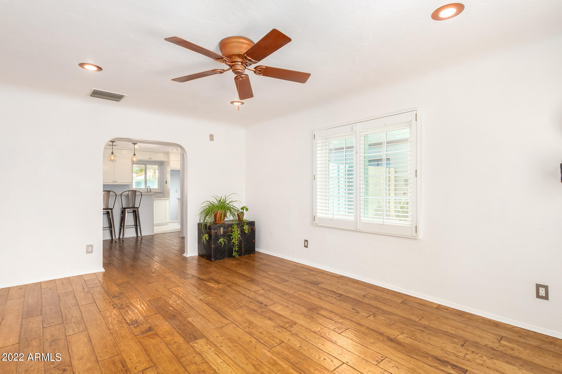 1330 East Granada Road Phoenix, AZ 85006 - Photo 6 of 24 a view of a livingroom with wooden floor and a ceiling fan