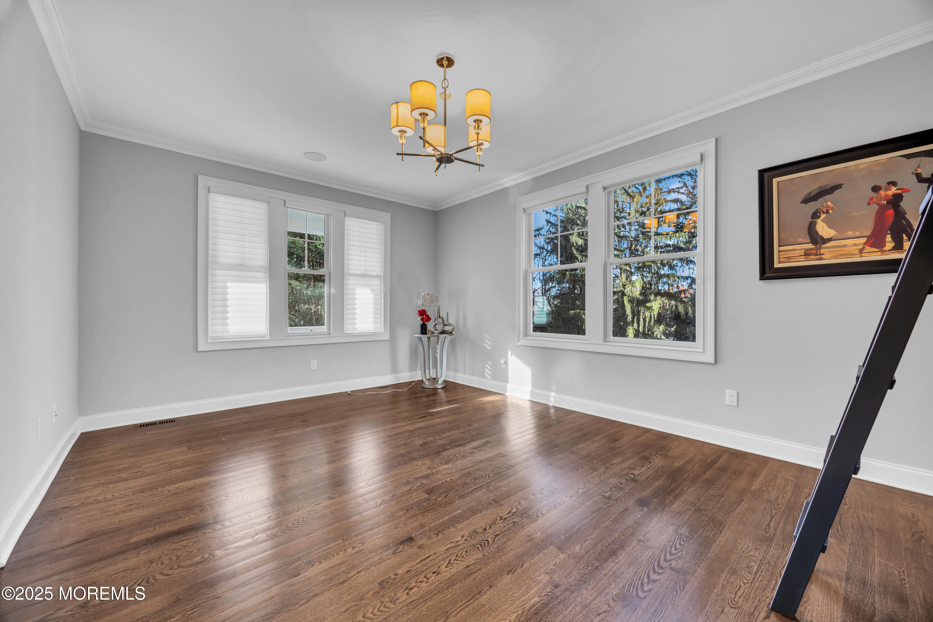 145 Heulitt Road Colts Neck, NJ 07722 - Photo 12 of 59 a view of an empty room with wooden floor and windows